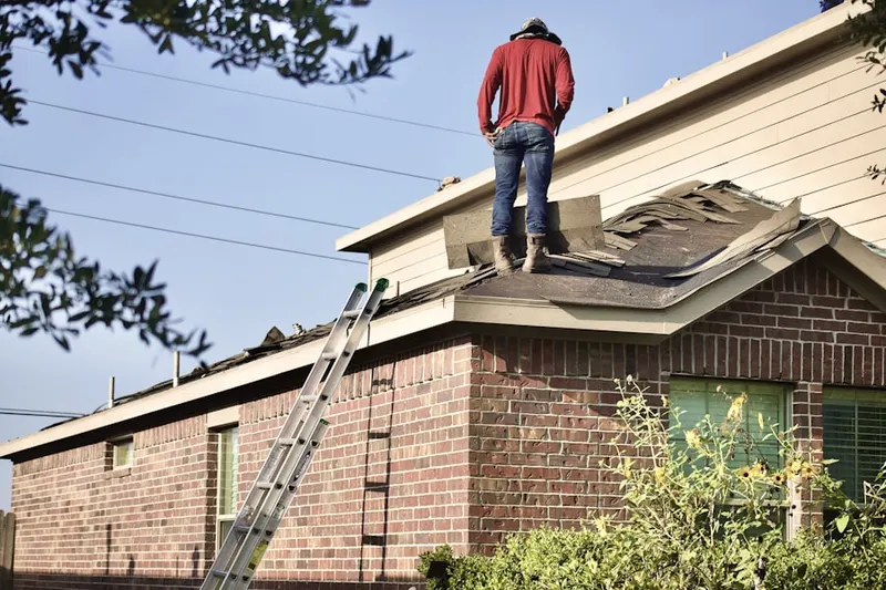 Professional roofer working on a residential roof in Lower Moreland